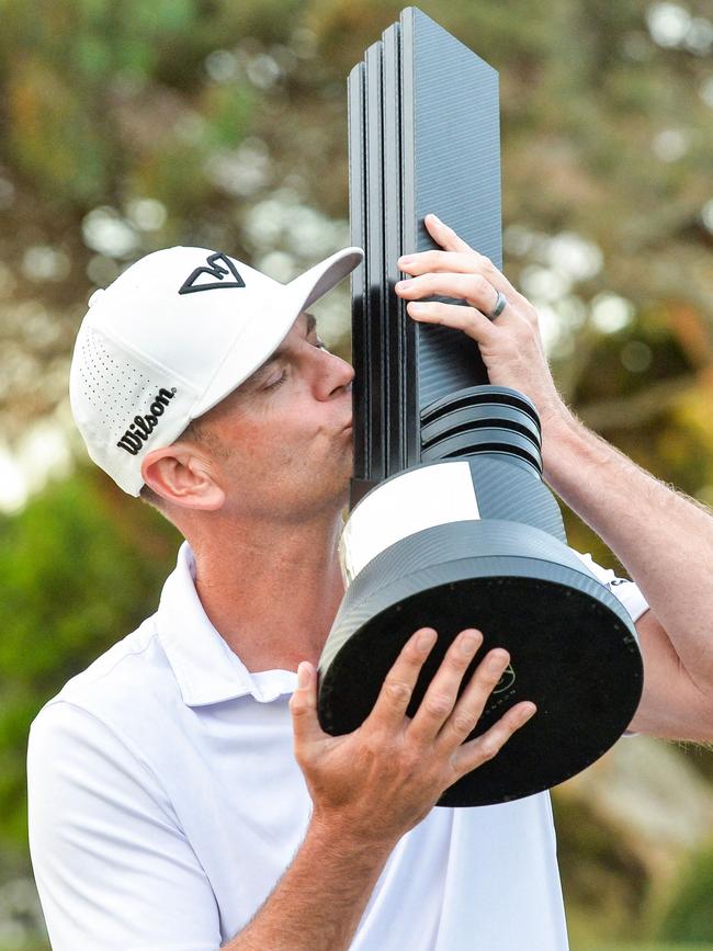 Brendan Steele of the US celebrates with the winner's trophy after the final round of LIV Golf Adelaide at the Grange Golf Club in Adelaide. Picture: Brenton Edwards / AFP