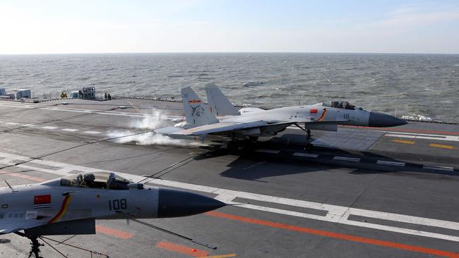 A Chinese fighter jet landing on the deck of the Liaoning aircraft carrier during military drills in the Bohai Sea, off China's northeast coast. Picture: AFP