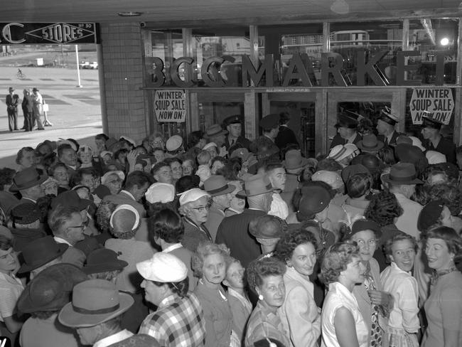 1957: Police hold back the crush of shoppers at BCC market, one of 25 stores in the new Allan and Stark Ltd drive-in shopping centre at Chermside, Brisbane.