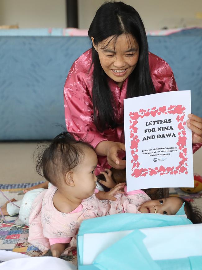 Nima and Dawa, with mum Bhumchu, receive letters from kidsnews.com.au. Picture: Alex Coppel