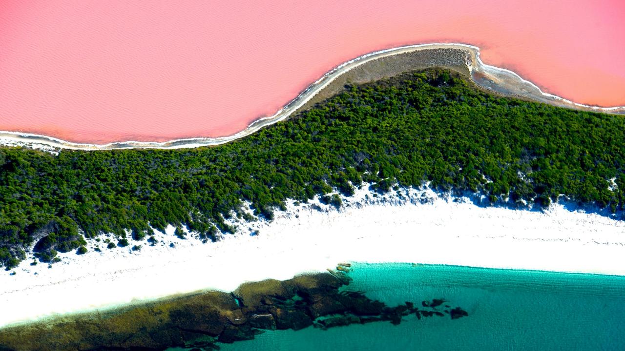 The contrasting colours of Lake Hillier, coastal plants, white sand and blue sea on Western Australia’s coast near Esperance. Picture: Ockert le Roux