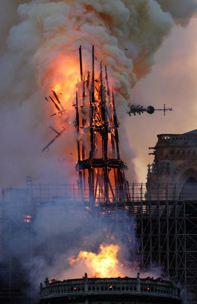 The steeple collapses as smoke and flames engulf the Notre-Dame Cathedral in Paris on April 15, 2019. (Photo by Geoffroy VAN DER HASSELT / AFP)