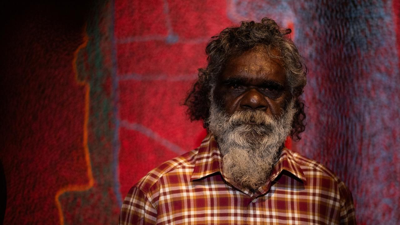 Telstra National Aboriginal and Torres Strait Islander Art Awards winner Noli Rictor, a Pitjantjatjara man, standing next to his artwork Kamanti which depicts his own Spinifex country at the Museum and Art Gallery of the Northern Territory (MAGNT), on Larrakia Country, Darwin. Picture: Pema Tamang Pakhrin