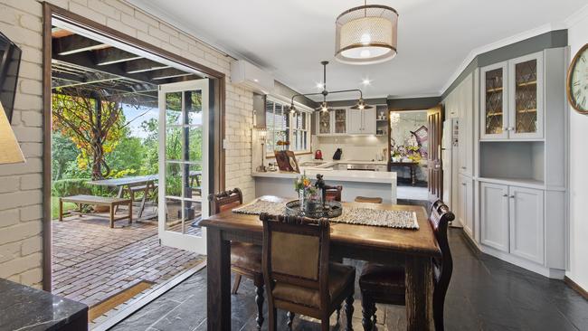 The more conventional kitchen/meals area flows out to a leafy entertainment area.