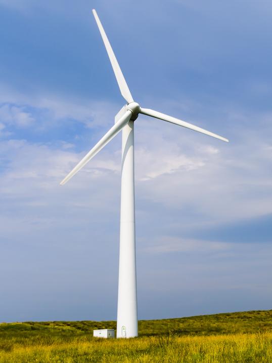 Silhouetted wind turbine at a rural windfarm.