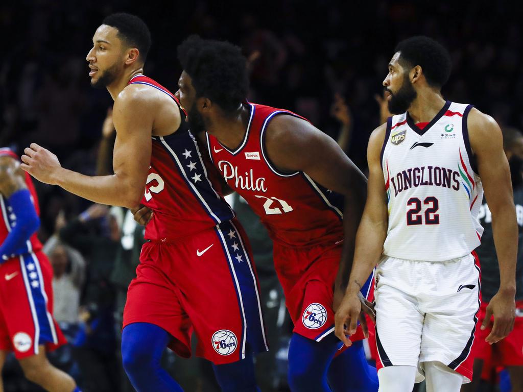 Simmons is trying to play it down but Joel Embiid can't contain himself. (AP Photo/Matt Rourke)