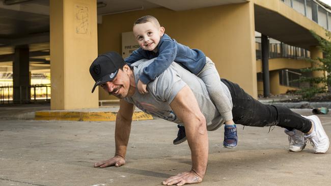 Gold's Gym Toowoomba franchise co-owner Joe Sorbara does a push-up with his son Lincoln on his back at the site of the former Aldi Clifford Gardens that is being converted into a Gold's Gym. Picture: Kevin Farmer