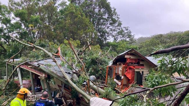 A house crushed by a tree at Currumbin Valley in the build-up to Cyclone Alfred. Picture: Qld Ambulance Service, Facebook.