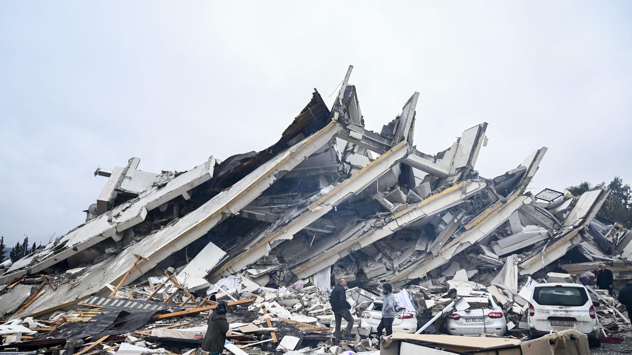 HATAY, TURKIYE - FEBRUARY 06: A view of a collapsed building in Hatay, Turkiye after 7.7 and 7.6 magnitude earthquakes hits Turkiye's Hatay, on February 06, 2023. Disaster and Emergency Management Authority (AFAD) of Turkiye said the 7.7 magnitude quake struck at 4.17 a.m. (0117GMT) and was centered in the Pazarcik district and 7.6 magnitude quake struck in Elbistan district in the province of Kahramanmaras in the south of Turkiye. Gaziantep, Sanliurfa, Diyarbakir, Adana, Adiyaman, Malatya, Osmaniye, Hatay, and Kilis provinces are heavily affected by the earthquakes. (Photo by Ercin Erturk/Anadolu Agency via Getty Images)