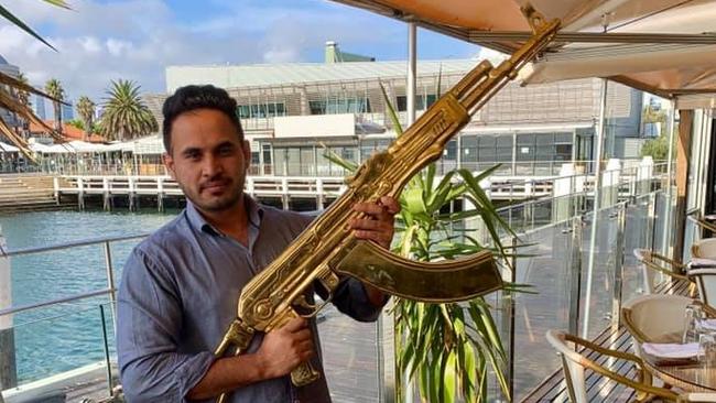 Arshdeep Khakh poses with a golden replica AK-47 at Waterfront.