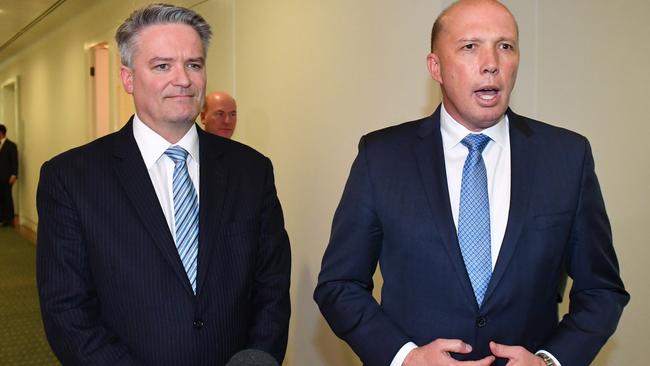 Mathias Cormann and Peter Dutton leave the Liberal party room meeting on Friday. Picture: AAP.