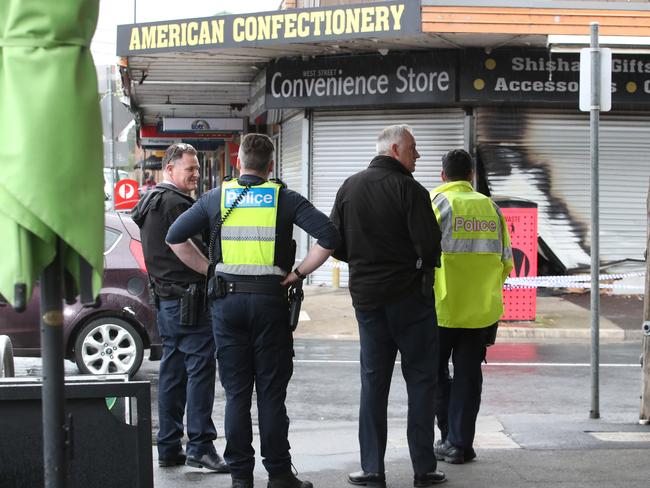 Arson squad detectives outside the burnt-out tobacco store on West St in Hadfield. Picture: David Crosling