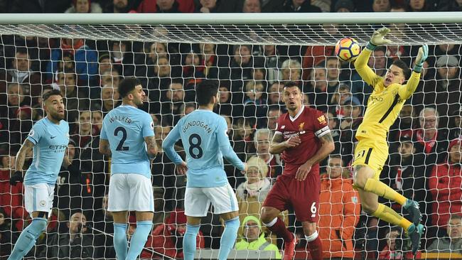 Ederson (R) fails to hold the ball as he attempts a catch during the English Premier League football match between Liverpool and Manchester City at Anfield.