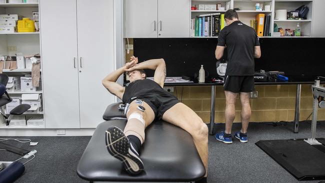 Hartlett with club doctor Mark Fisher in the wake of his knee reconstruction. Picture SARAH REED