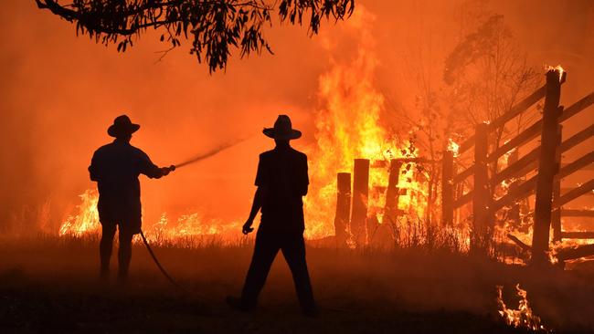 Hillsville residents defend their property near Taree, some 350km north of Sydney from a fire in November, 2019. Picture: AFP