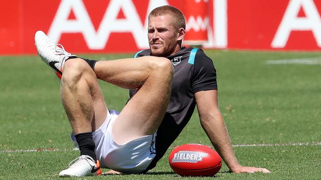 Tom Clurey of the Adelaide Power AFL club stretches at Richmond Oval. Picture: Getty Images