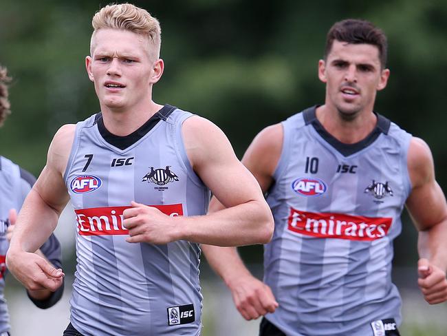 Collingwood footy training at Olympic Park. Taylor Adams, Adam Treloar and Scott Pendlebury do extra running at the end of training.Pic : Michael Klein