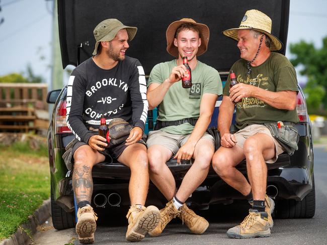 Tradies Kobe Timms, Ollie Amici and Craig Trahair have a knock-off Carlton Draught after a long day on the tools. Picture: Mark Stewart