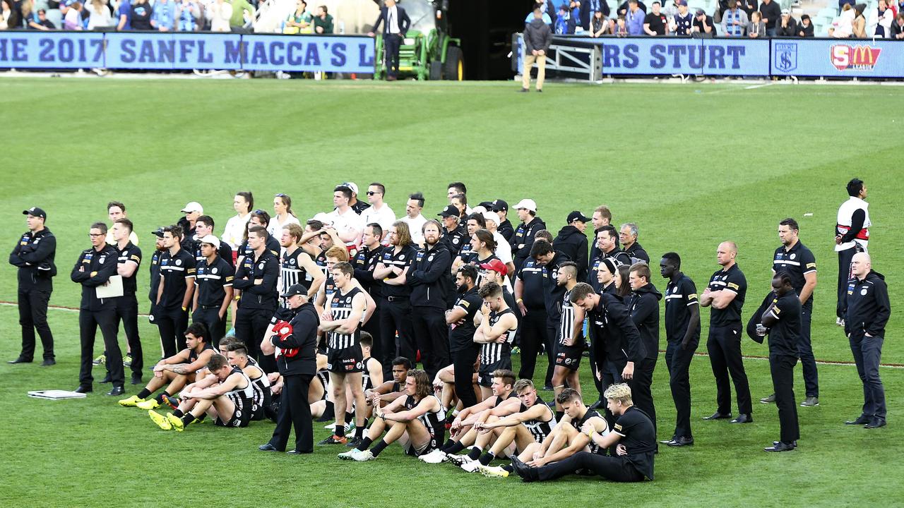 A shattered Port Adelaide watch the presentations. Picture Sarah Reed