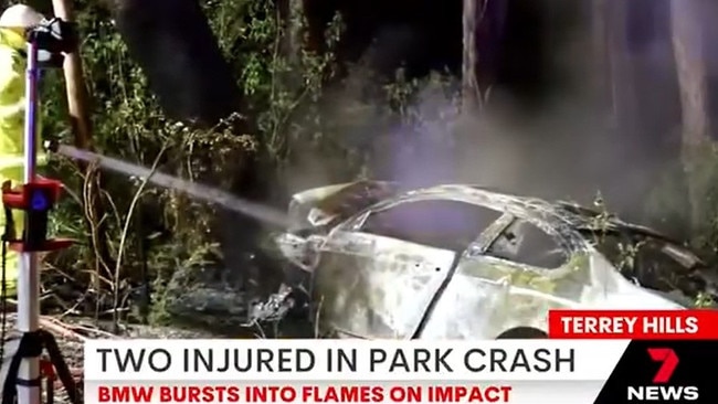 A firefighter douses the wrecked BMW 335i coupe with water. Picture: 7News