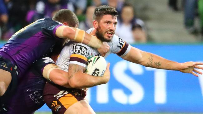 Matt Gillett is wrapped up by the Storm defence.