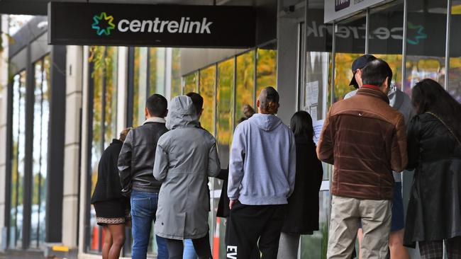 People queue up outside a Centrelink office in Melbourne.