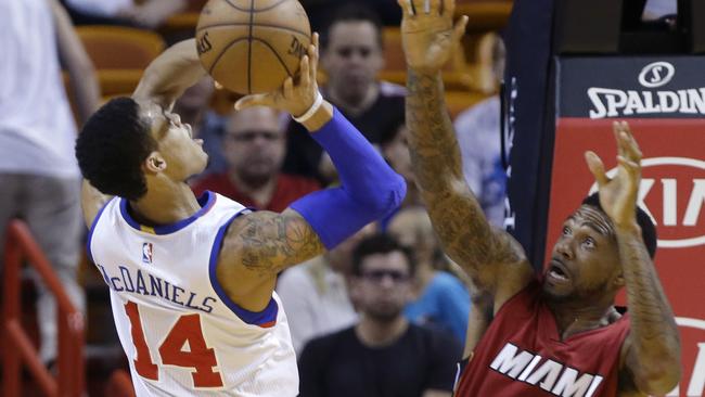 K.J. McDaniels shoots and is fouled by Miami Heat forward Udonis Haslem/