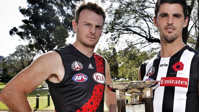 Collingwood skipper Scott Pendlebury and essendon skipper Brendon Goddard with the cup they will battlefor on Anzac Day . Pic: Michael Klein.