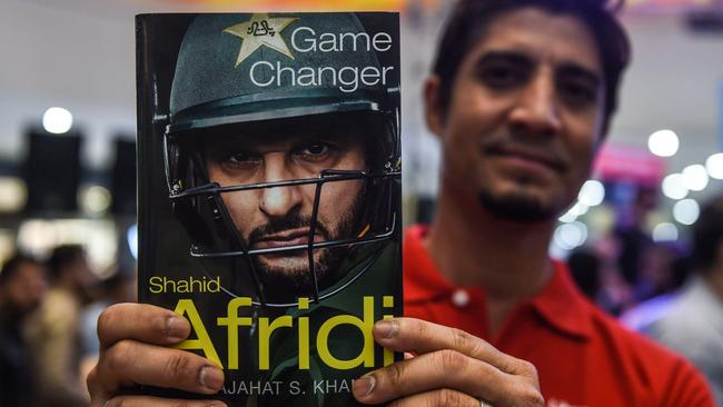 Shahid Afridi with his book, which lifts the lid on his dramatic walk out on the team.