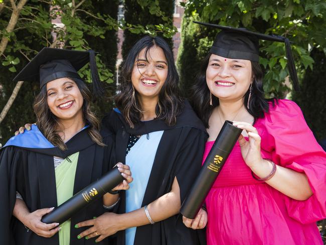 Bachelor of Nursing graduates Anusha Chaudhary (left) and Santoshi Dhungana with a study colleague Asmita Shrestha, who has already graduated, at a UniSQ graduation ceremony at Empire Theatres, Tuesday, October 31, 2023. Picture: Kevin Farmer