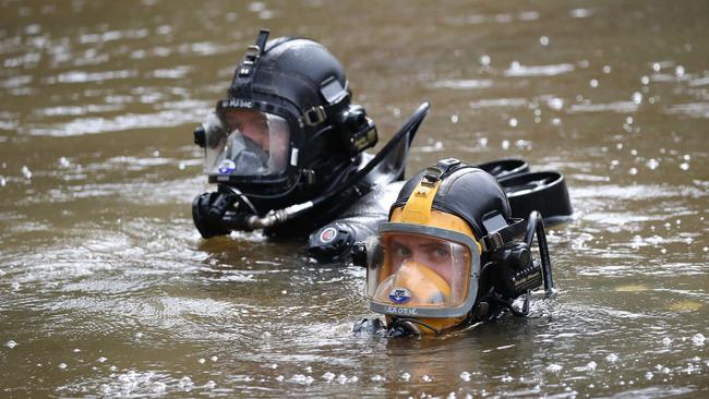 Police divers search dams on the property. Picture: David Swift