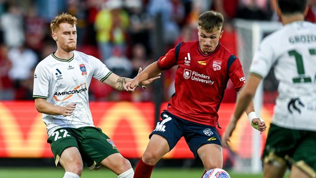 Luka Jovanovic of Adelaide United competes with Phillip Cancar of the Newcastle Jets. Picture: Mark Brake/Getty Images