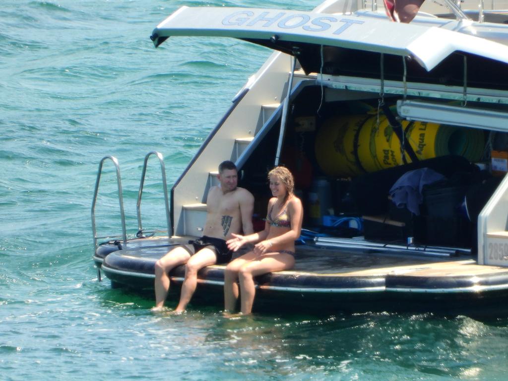 Former Australian cricket captain Michael Clarke pictured on his super cruiser Ghost for a lazy afternoon on the harbour with his assistant Sasha Armstrong. Picture: Matrix