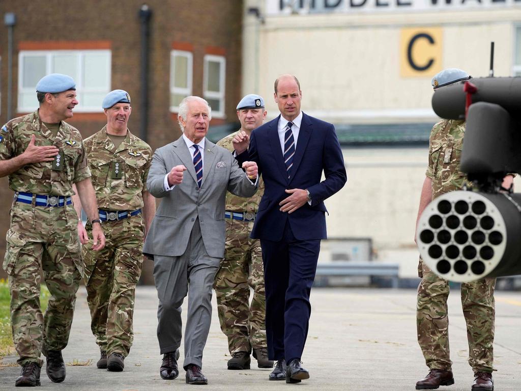 King Charles and Prince William walk beside an armed Apache helicopter at the Army Aviation Centre following a hand over ceremony for the role of Colonel-in-Chief of the Army Air Corps. Picture: AFP