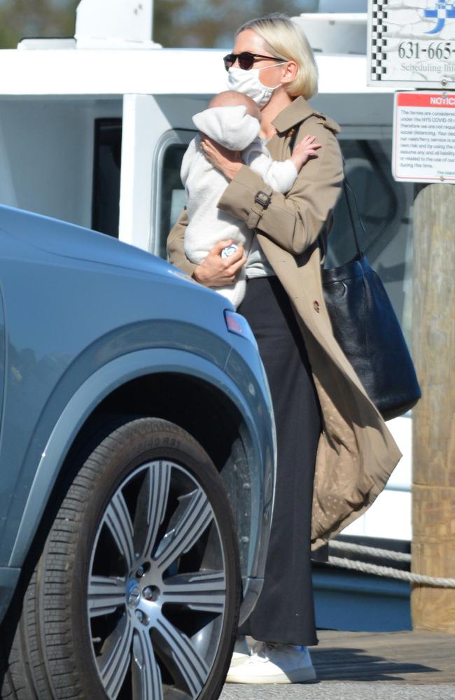 The actress cradled her baby close as she headed out for the family trip.