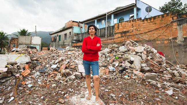 Maria da Penha in front of the shanty town rubble where her house once stood. Picture: Ariel Guevara.