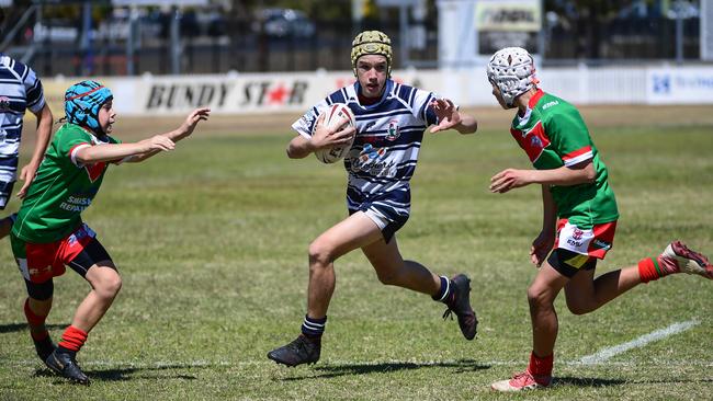 Brothers under 14s Zander Evans tries to run between Samuel Walker and William Mitchell.