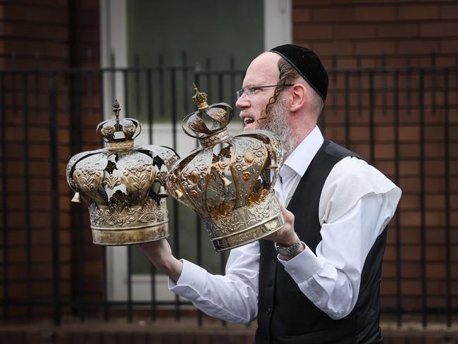 Religious artefacts are removed from the synagogue after it was torched in fire. Picture: David Caird