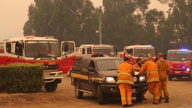 Firefighters opposite the Kermandie Hotel in Port Huon today as fires approach. Picture: NIKKI DAVIS-JONES