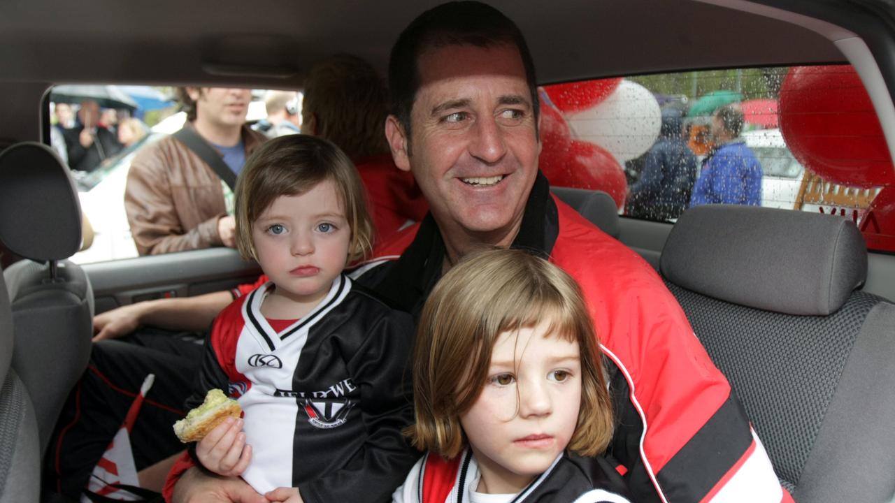 St Kilda Coach Ross Lyon enjoys the moment with his daughters Annecy and Nikita during the 2009 AFL Grand Final Parade through the streets of Melbourne.