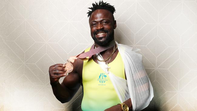 Aussie weightlifter Francois Etoundi injured himself, won bronze and became a viral star after his medal ceremony. Picture: Nigel Hallett