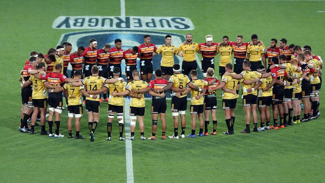 HAMILTON, NEW ZEALAND - MARCH 15: The Chiefs and Hurricanes come together for a moments silence prior to the start of the round five Super Rugby match between the Chiefs and the Hurricanes at FMG Stadium on March 15, 2019 in Hamilton, New Zealand. (Photo by Michael Bradley/Getty Images)