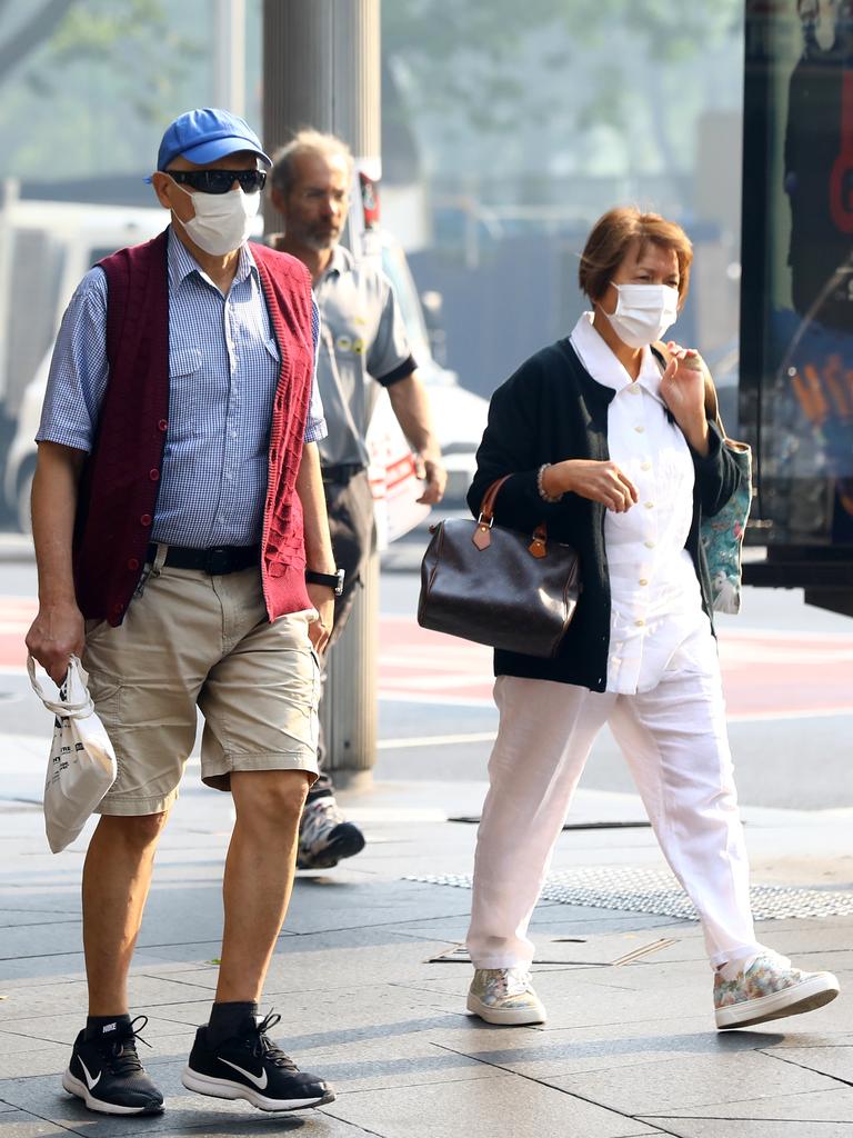 As smoke from bushfires engulfs Sydney, morning commuters are pictured wearing face masks as they make their way to work. Picture: MATRIX