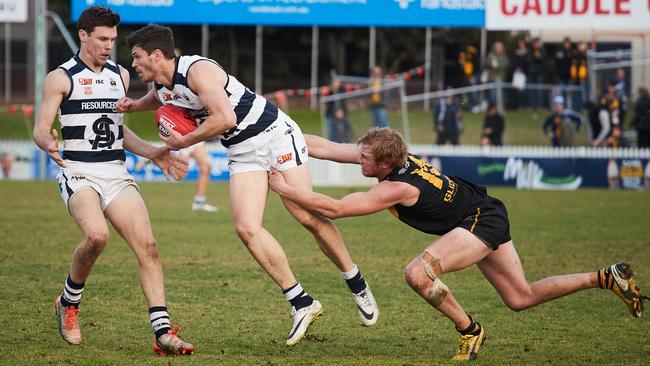 South's Luke Durdin gets tackled by Glenelg's Josh Scott at Gliderol Stadium.