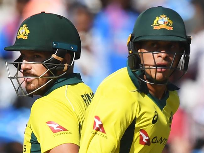 Australian cricketer Aaron Finch (L) and Usman Khawaja run between the wickets during the third one-day international (ODI) cricket match between India and Australia at the Jharkhand State Cricket Association International Cricket Stadium, in Ranchi on March 8, 2019. (Photo by DIBYANGSHU SARKAR / AFP) / ----IMAGE RESTRICTED TO EDITORIAL USE - STRICTLY NO COMMERCIAL USE-----