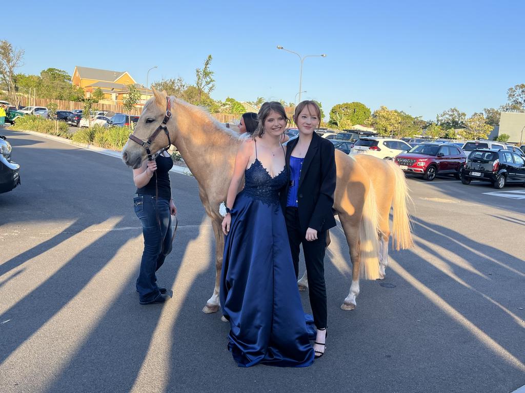 Sheree Behrendt and Lilith Felgendrejeris arrive at the Aldridge State High School formal on horseback.