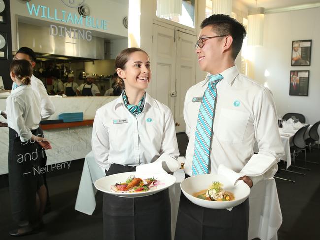 Hospitality student Georgina McCarthy, pictured with colleague David Bae, provides extra service for her guests. Picture: Richard Dobson