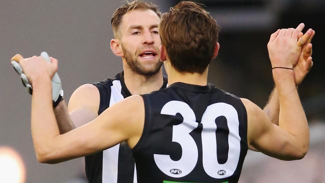 Travis Cloke celebrates a goal with Darcy Moore.