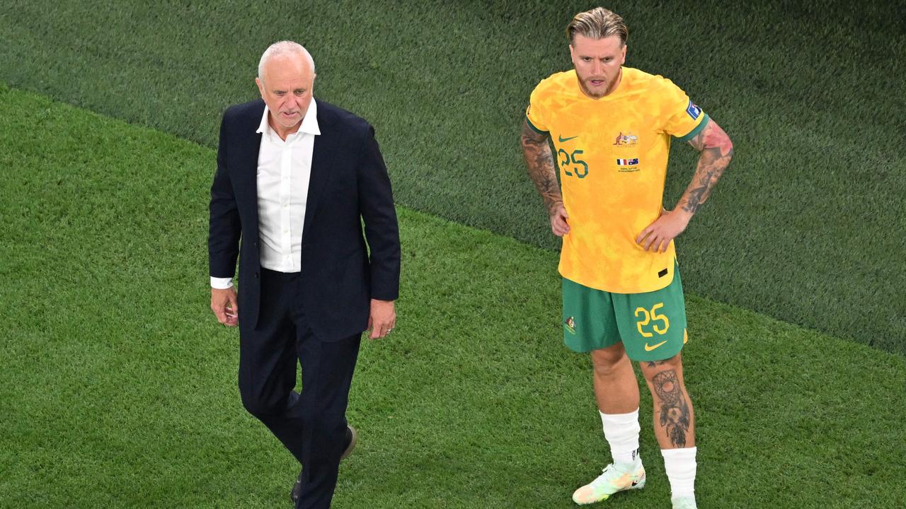 Australia's coach #00 Graham Arnold (L) stands next to Australia's forward #25 Jason Cummings before entering the pitch as a substitute during the Qatar 2022 World Cup Group D football match between France and Australia at the Al-Janoub Stadium in Al-Wakrah, south of Doha on November 22, 2022. (Photo by FranÃ§ois-Xavier MARIT / AFP)