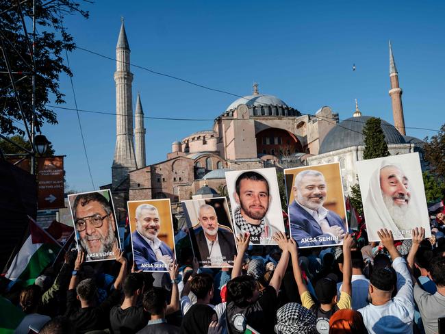 TOPSHOT - Pro-Palestinian demonstrators take part in a rally to condemn the assassination of Hamas leader Ismail Haniyeh, at Hagia Sophia Square in Istanbul, on August 3, 2024. Gathered at the call of several conservative and pro-government associations, thousands of demonstrators gathered to denounce the death of Hamas leader Ismail Haniyeh, after he was buried on August 2, 2024 in Qatar. Israel, accused by Hamas, Iran and others of the attack which killed the Hamas leader, has not directly commented on the assassination. (Photo by KEMAL ASLAN / AFP)